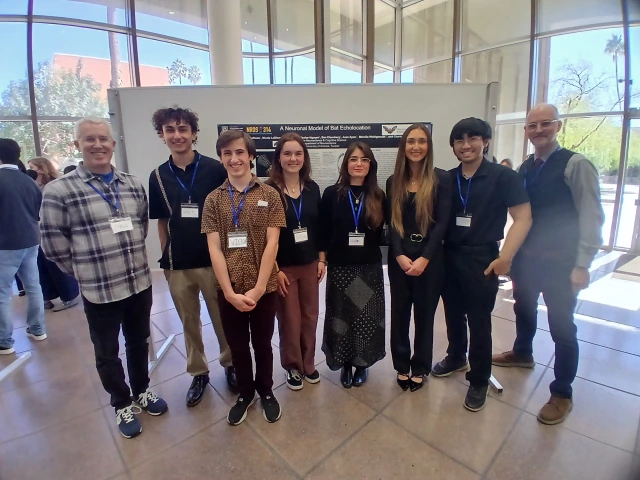 people in front of poster 