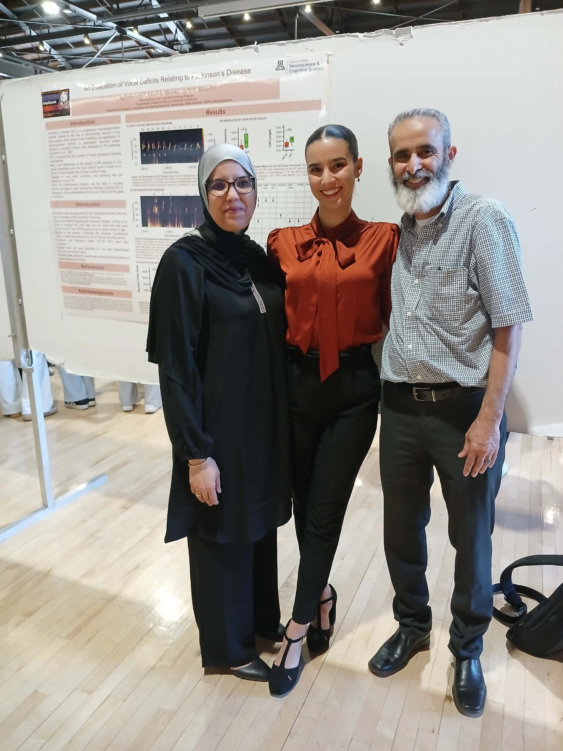 Undergraduate student standing next to their Capstone Project
