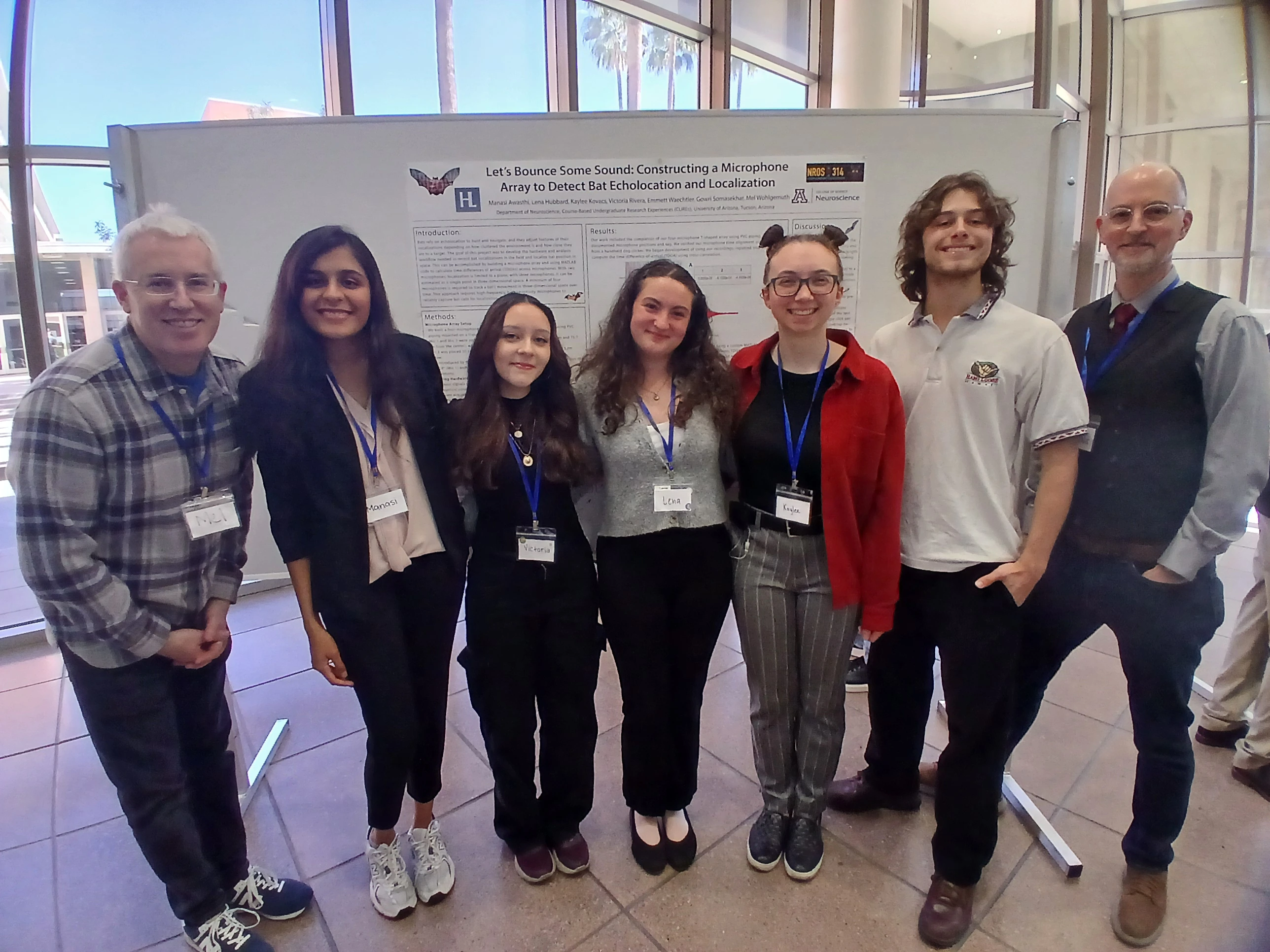 people in front of poster 